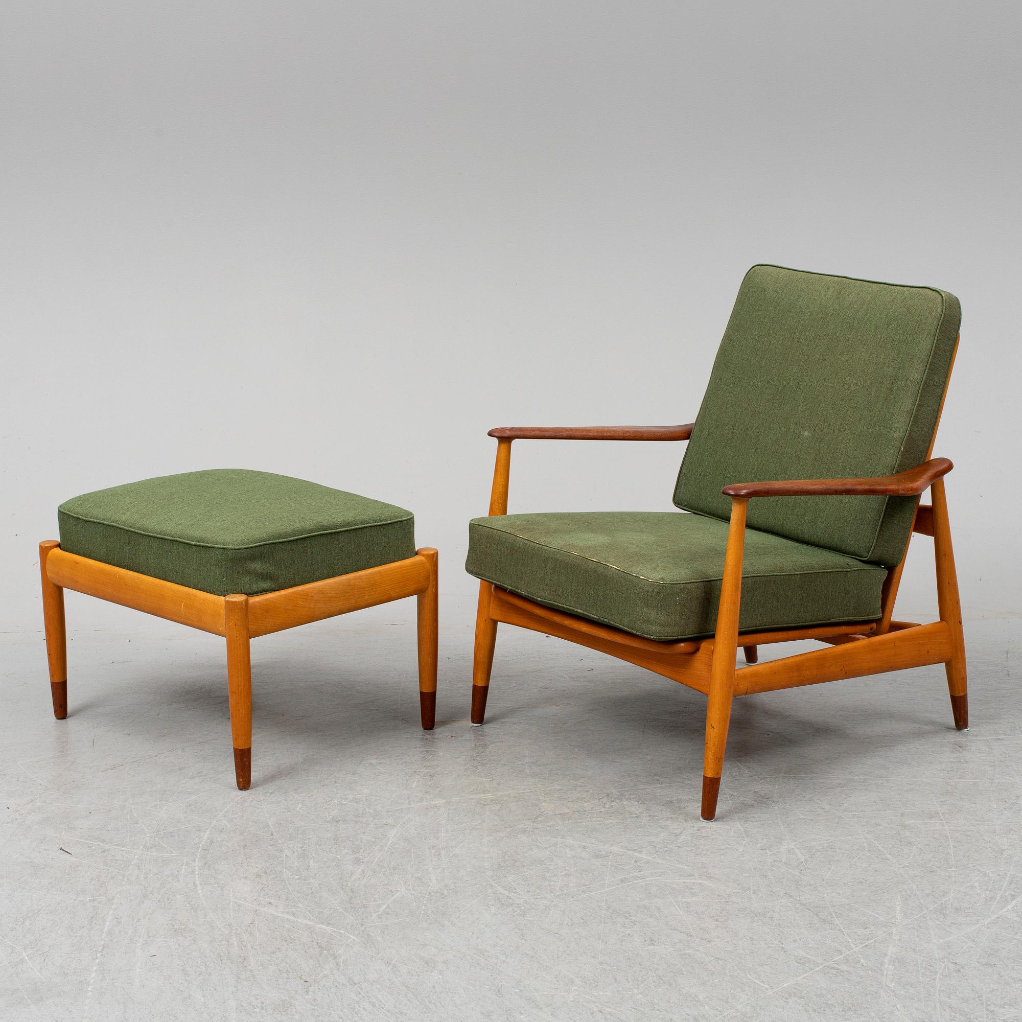 A 1950's beech and teak model FD 161 easy chair with stool by Arne Vodder for France & Son.