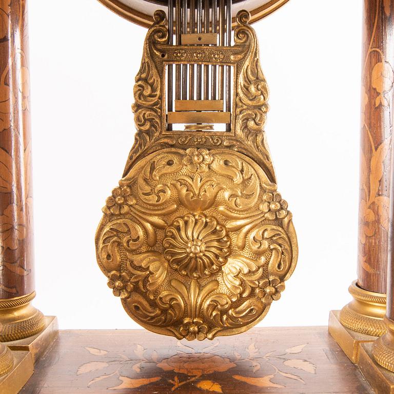 A late Empire mid 19th century veneered table clock.