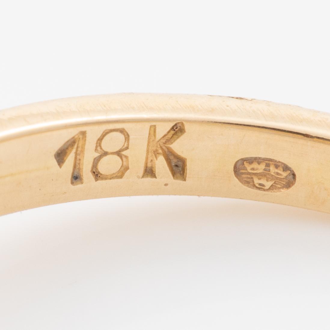 Ring, 18K gold with a synthetic white stone.