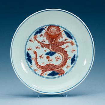 1645. A blue and white and red overglaze dragon dish, presumably Republic with mark in underglaze blue.