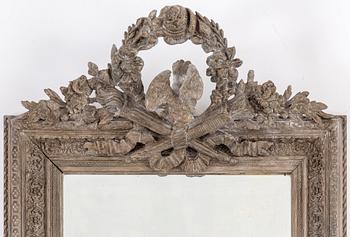 A carved wooden framed mirror, circa 1900.