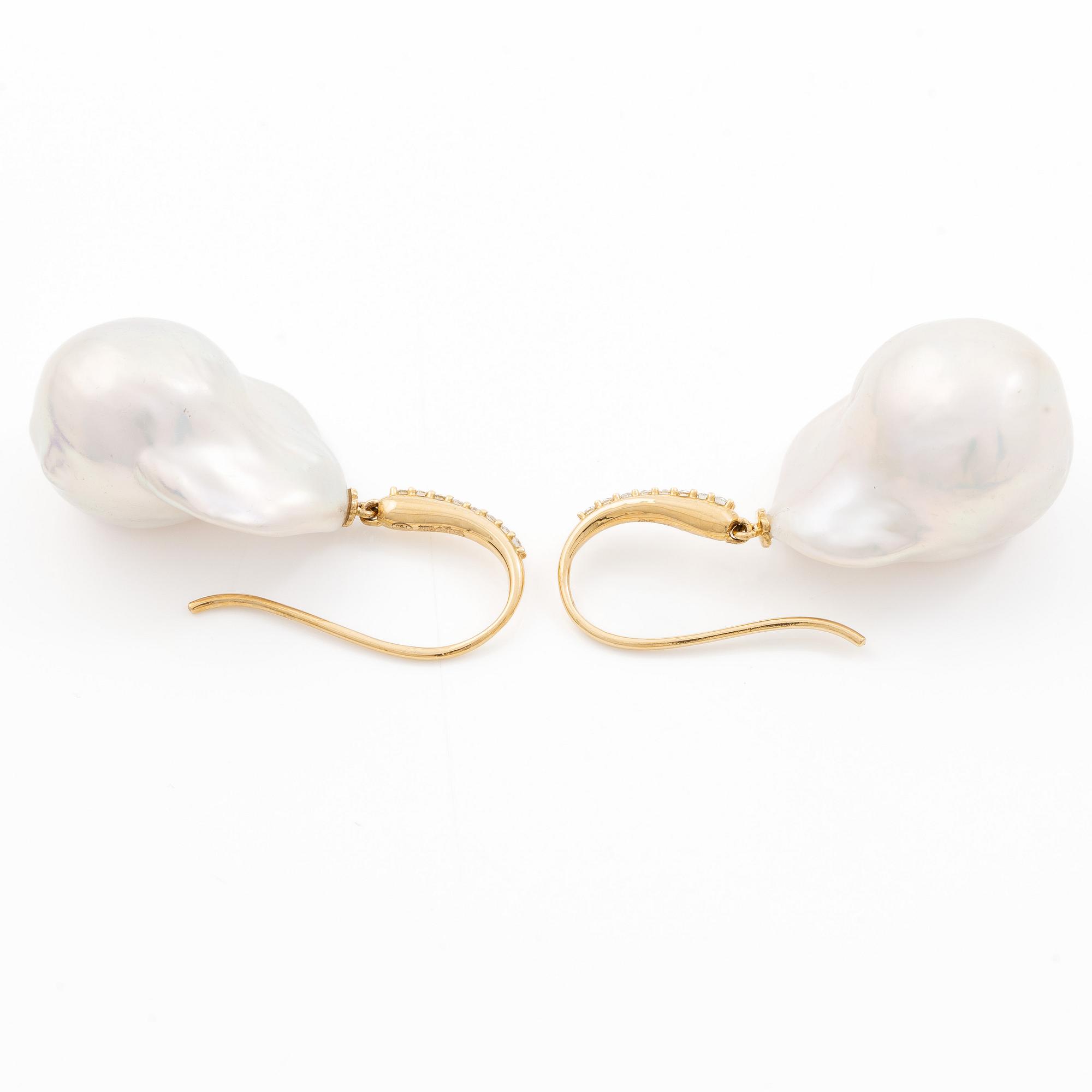 A pair of earrings with cultured baroque-shaped freshwater pearls and round brilliant-cut diamonds.