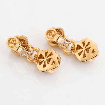 A pair of 18K gold earrings set with round brilliant-cut diamonds.