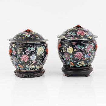 A pair of Famille Noir porcelain urns with covers, China, 20th century.