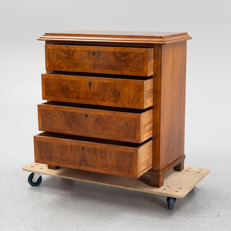 A walnut-veneered dresser, around 1900.