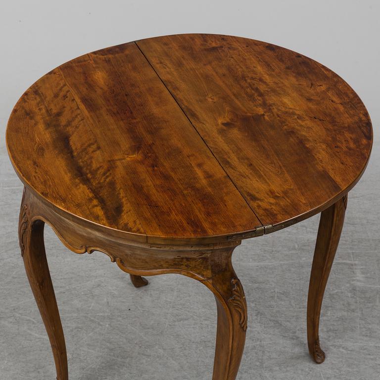 A rococo style card table from around year 1900.