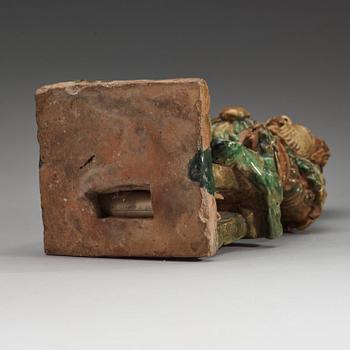 A green and yellow glazed roof tile figure of a warrior, Ming dynasty (1368-1644).