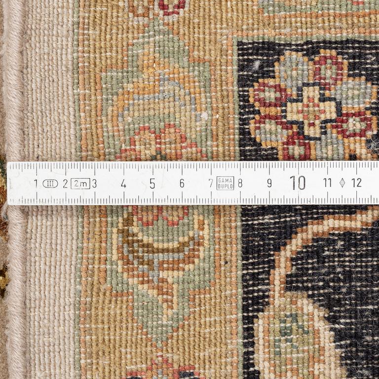 An oriental carpet, part silk, circa 311 x 242.