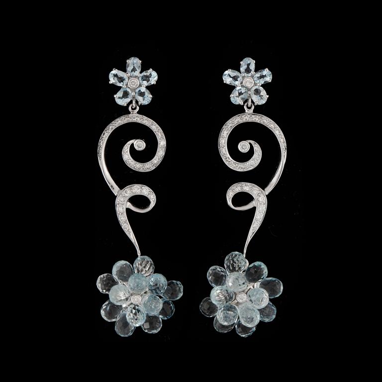 A pair of diamond and aquamarin earrings.