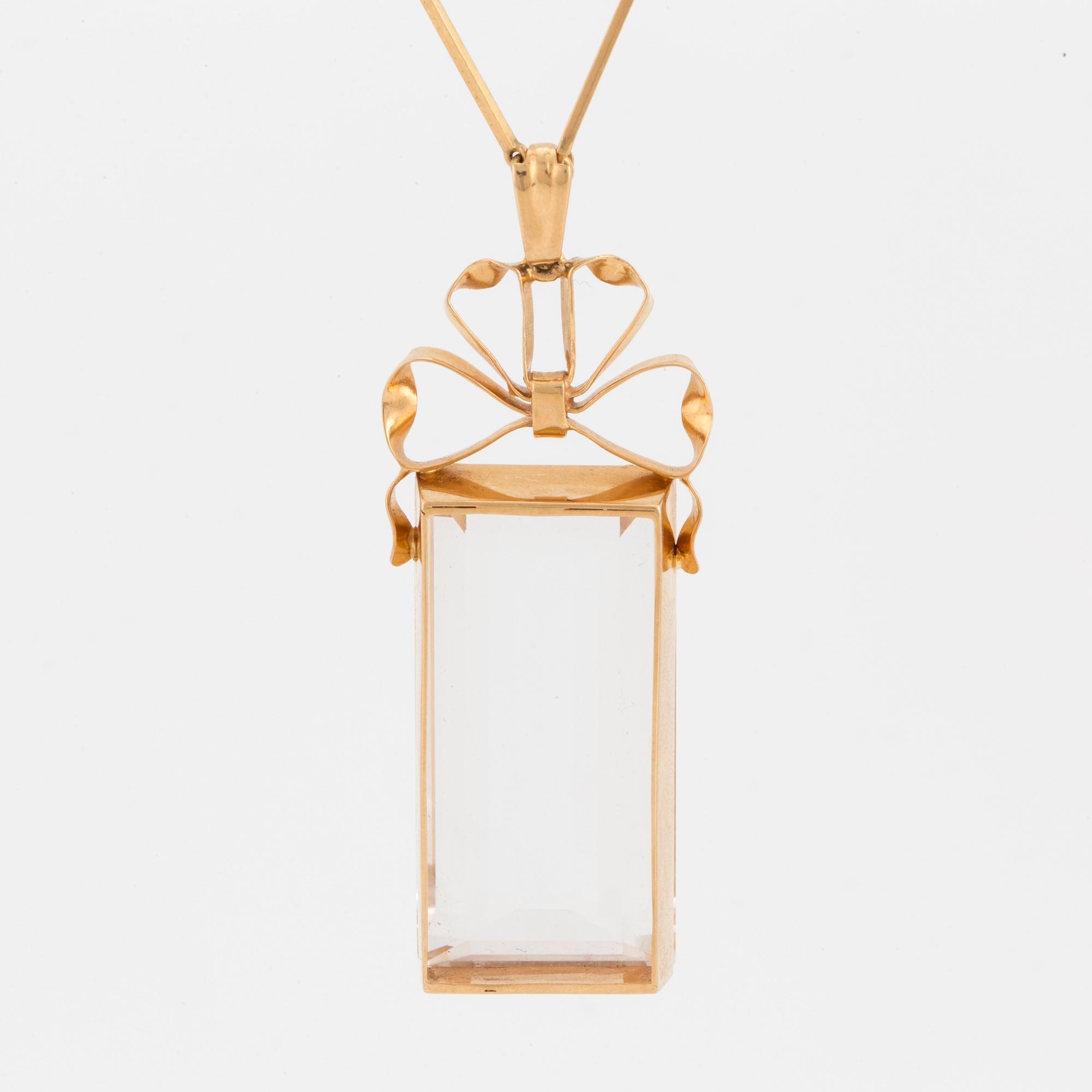A chain and a pendant set with step-cut quartz.