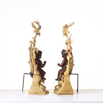A pair of Louis XV-style 19th century fire dogs.