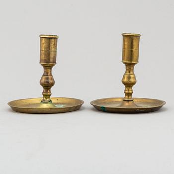 TWO CANDLESTICKS, brass, ca 1800.