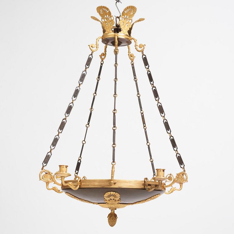 An Empire.style five-branch patinated and gilt bronze chandelier, later part of the 19th century.