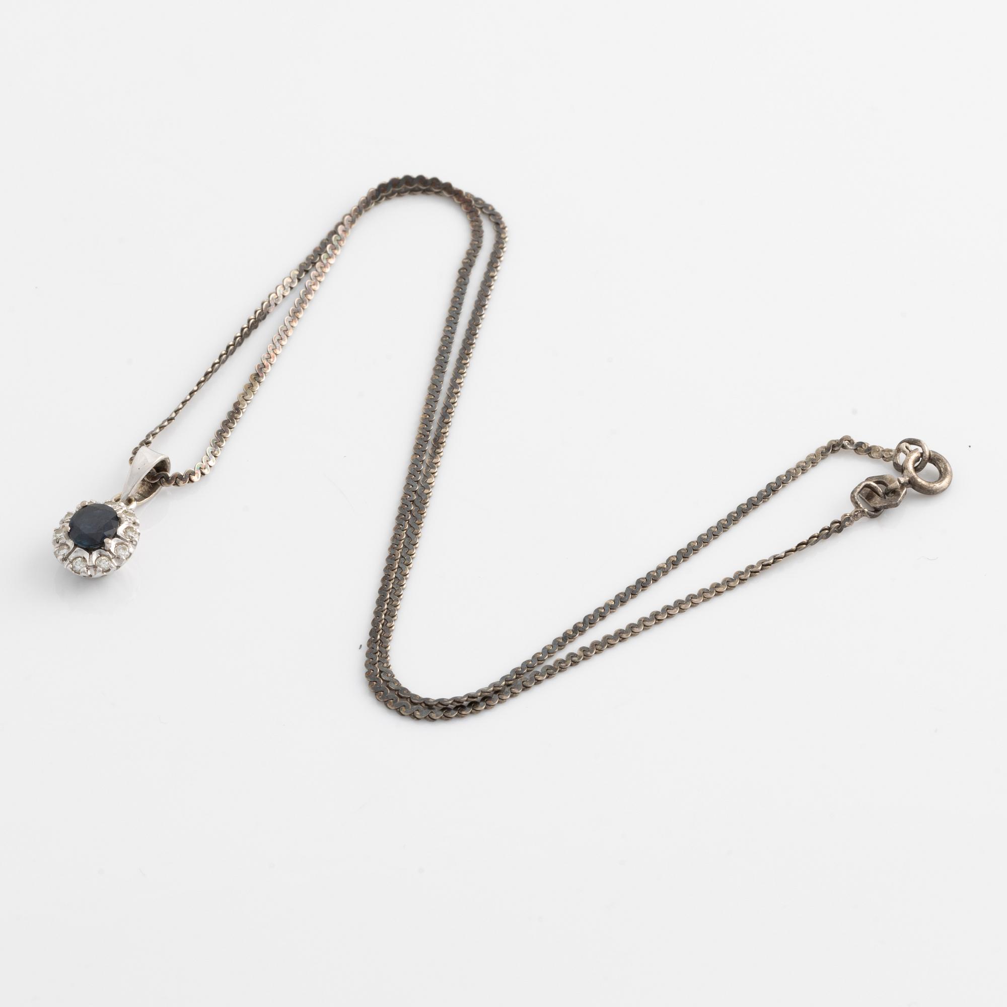 Pendant and a pair of earrings, white gold with sapphires and brilliant-cut diamonds.