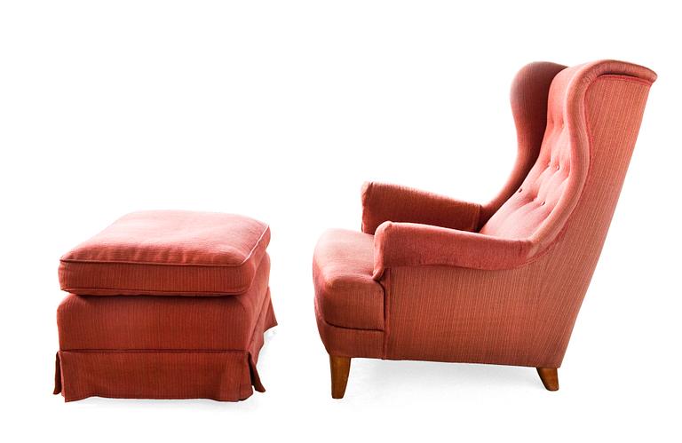 AN ARMCHAIR WITH OTTOMAN.