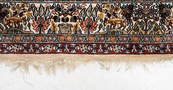 An oriental silk carpet, c. 305 x 205 cm.