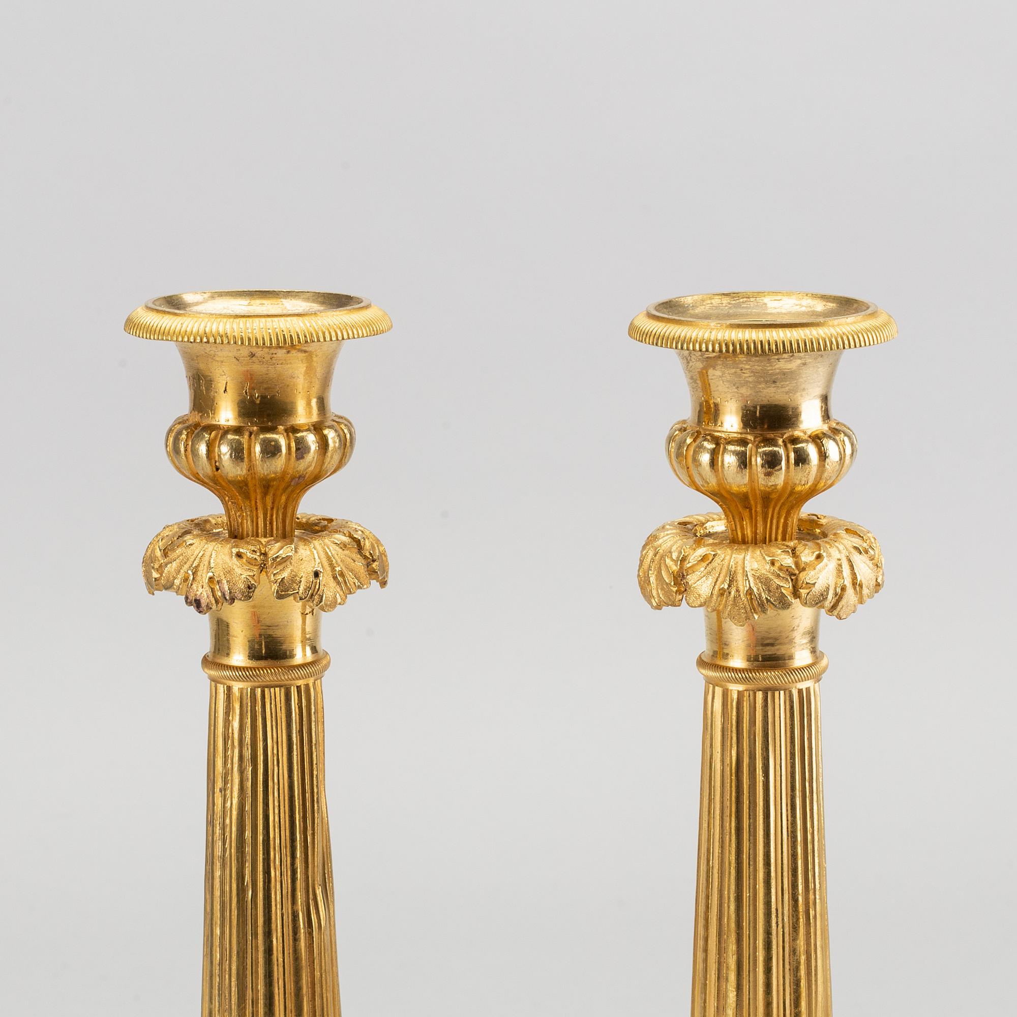 A pare of late empire candelsticks mid 19th century.