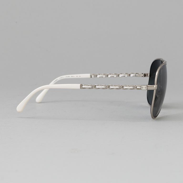 A pair of sunglasses by Chanel.