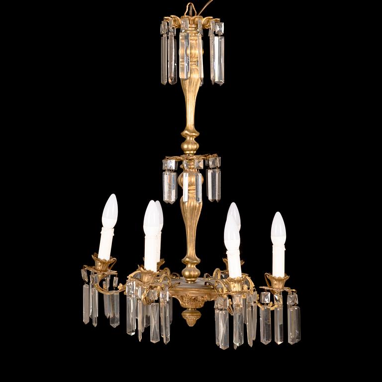 A brass chandelier with prisms, late 19th century. Height 75 cm.