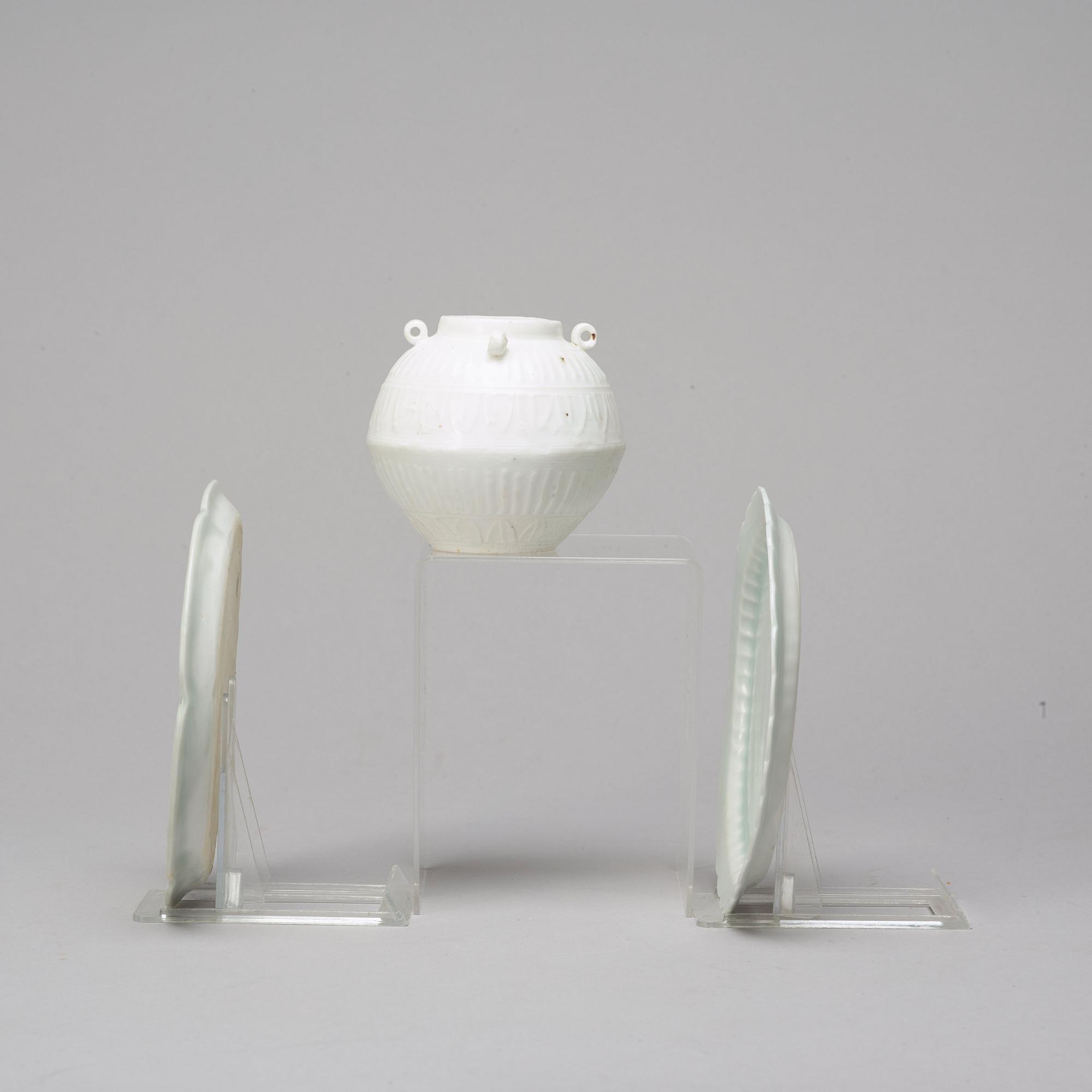 Two celadon glazed dishes and a white glazed jar, South East Asia, presumably 12th/17th Century.