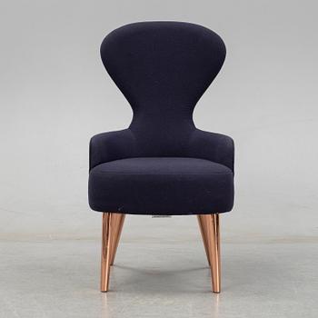 A Tom Dixon "Wingback Dining Chair" from Tom Dixon.
