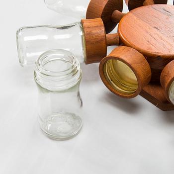 A Danish 1960s wall mounted spice rack in teak and glass from Digsmed.