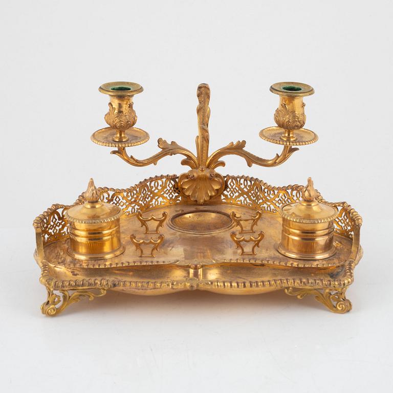A gilt inkwell and candle holder, around 1900.
