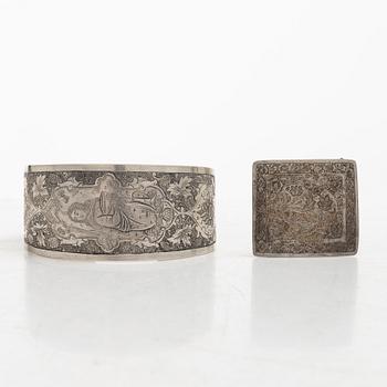Two silver buttons, a belt buckle, an armring and a box, Persia, first part of the 1900s.