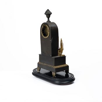 A French Charles X ormolu and patinated bronze mantel clock, ca 1820's.