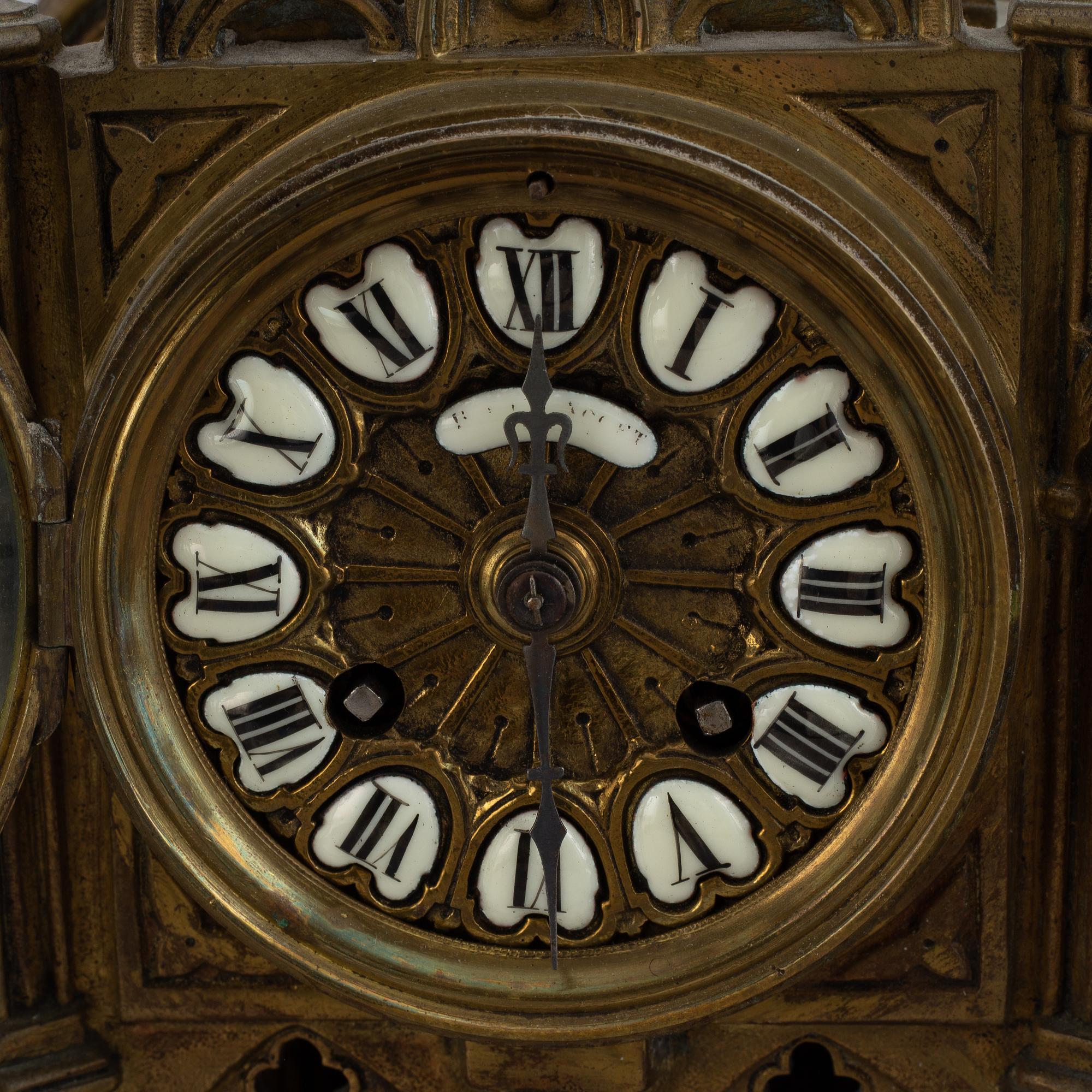 A mantle clock with pair of candelabra, late 19th century.