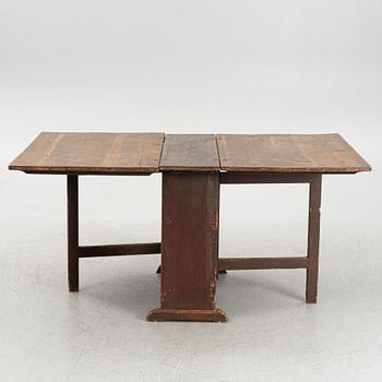 A drop-leaf table, 19th Century.