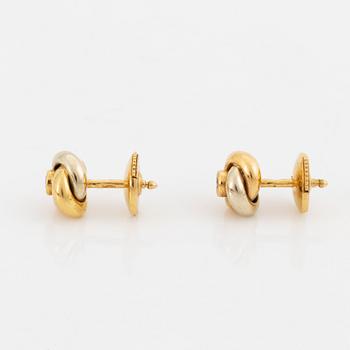 A pair of 18K gold Cartier "Trinity" earrings set with round brilliant-cut diamonds.