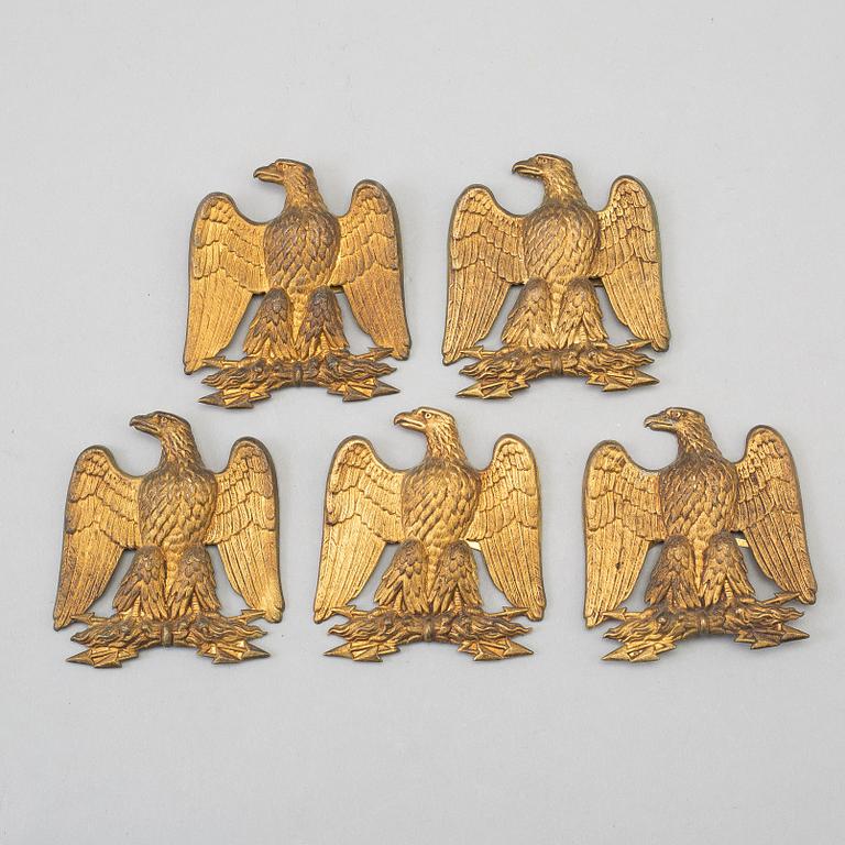 FIVE BRASS UNIFORM EMBLEMS, 19th century.