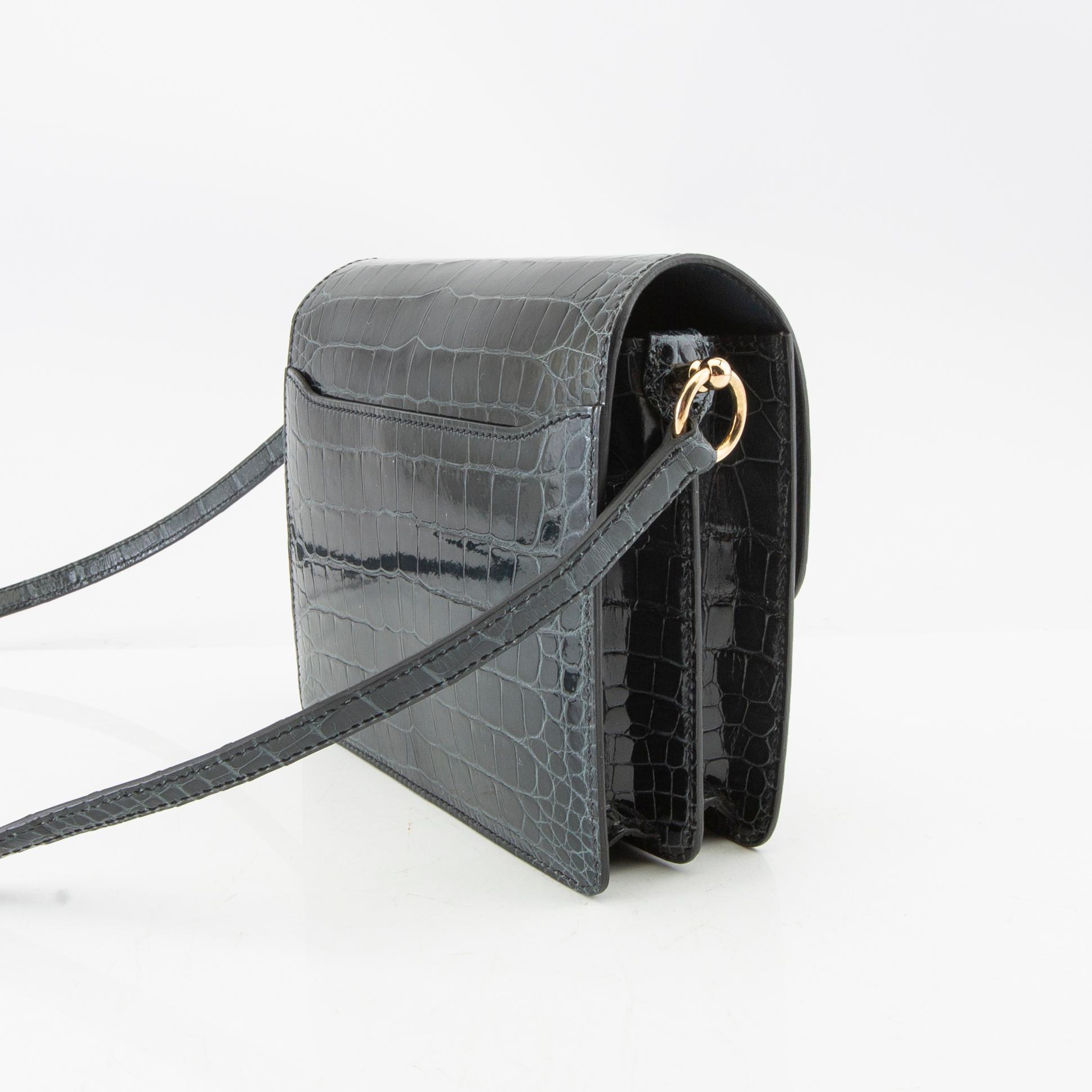 Hermès, bag "Green Shiny Alligator Mini Roulis 18 Permabrass Hardware" 2021.