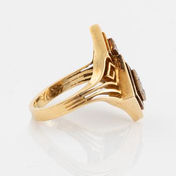 An Ilias Lalaounis ring in 18K gold set with eight-cut diamonds.