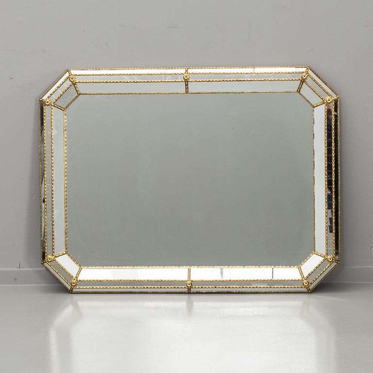 A WALL MIRROR MADE IN SPAIN.