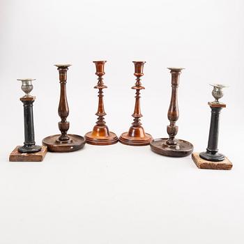 A set of three wooden pairs of candle sticks around 1900.