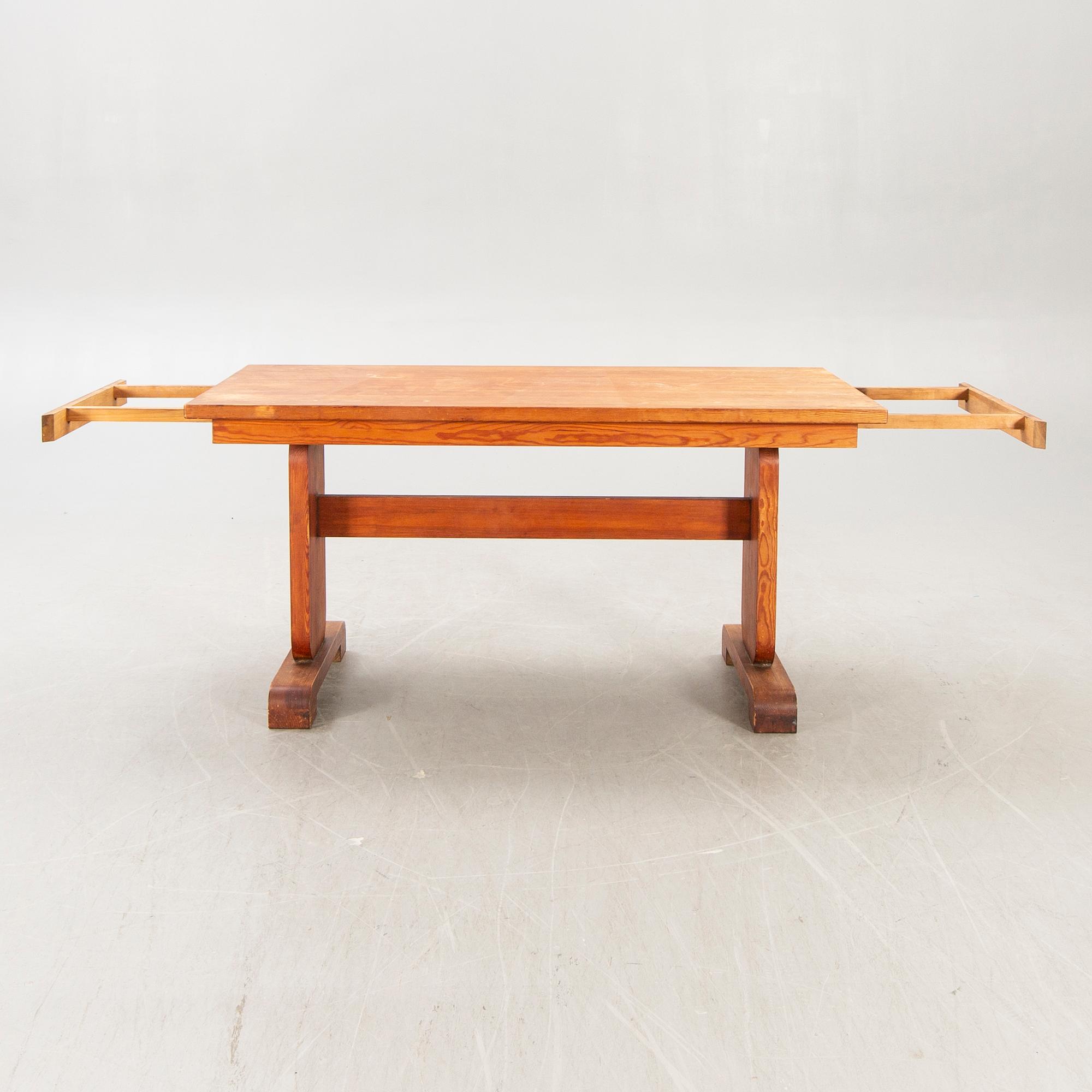 A 1940s pine dining table.