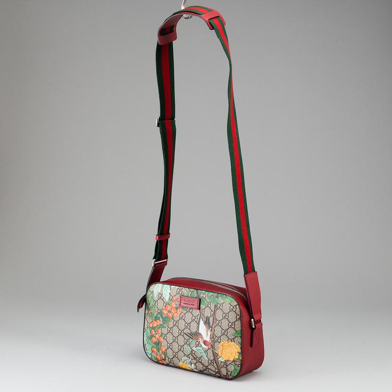 GUCCI, a patterned monogram canvas and leather bag.