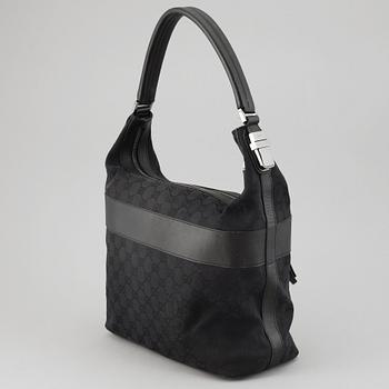 GUCCI, a canvas and leather bag.