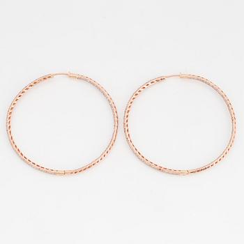 Rose gold and diamond hoop earrings.