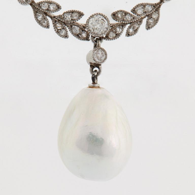 A platinum brooch set with old-cut diamonds and with a drop shaped pearl.