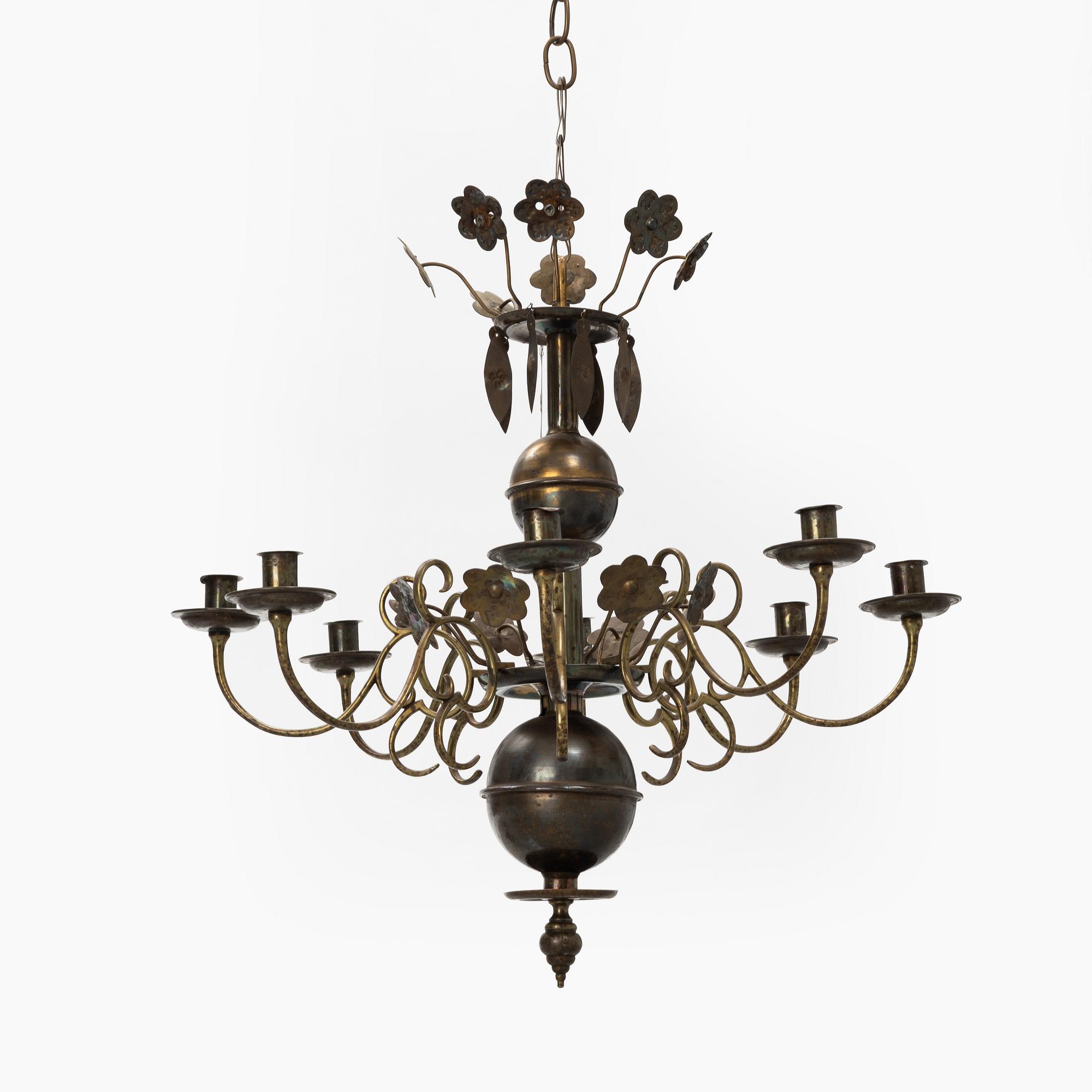 A Baroque style brass chandelier from around the year 1900.
