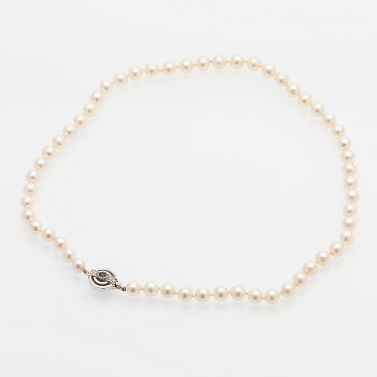 Pearl necklace, white gold clasp set with diamonds and a sapphire.