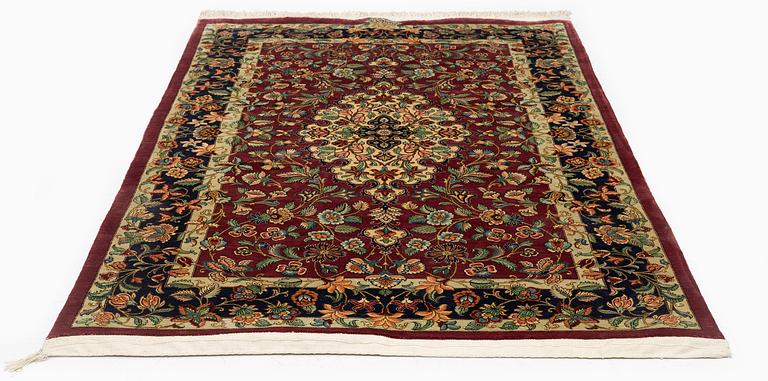 A silk Qum rug, Central Iran, signed, c. 170 x 101 cm.