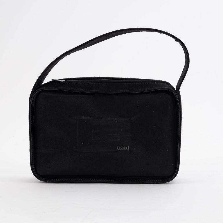 Gucci, a black satin handbag.