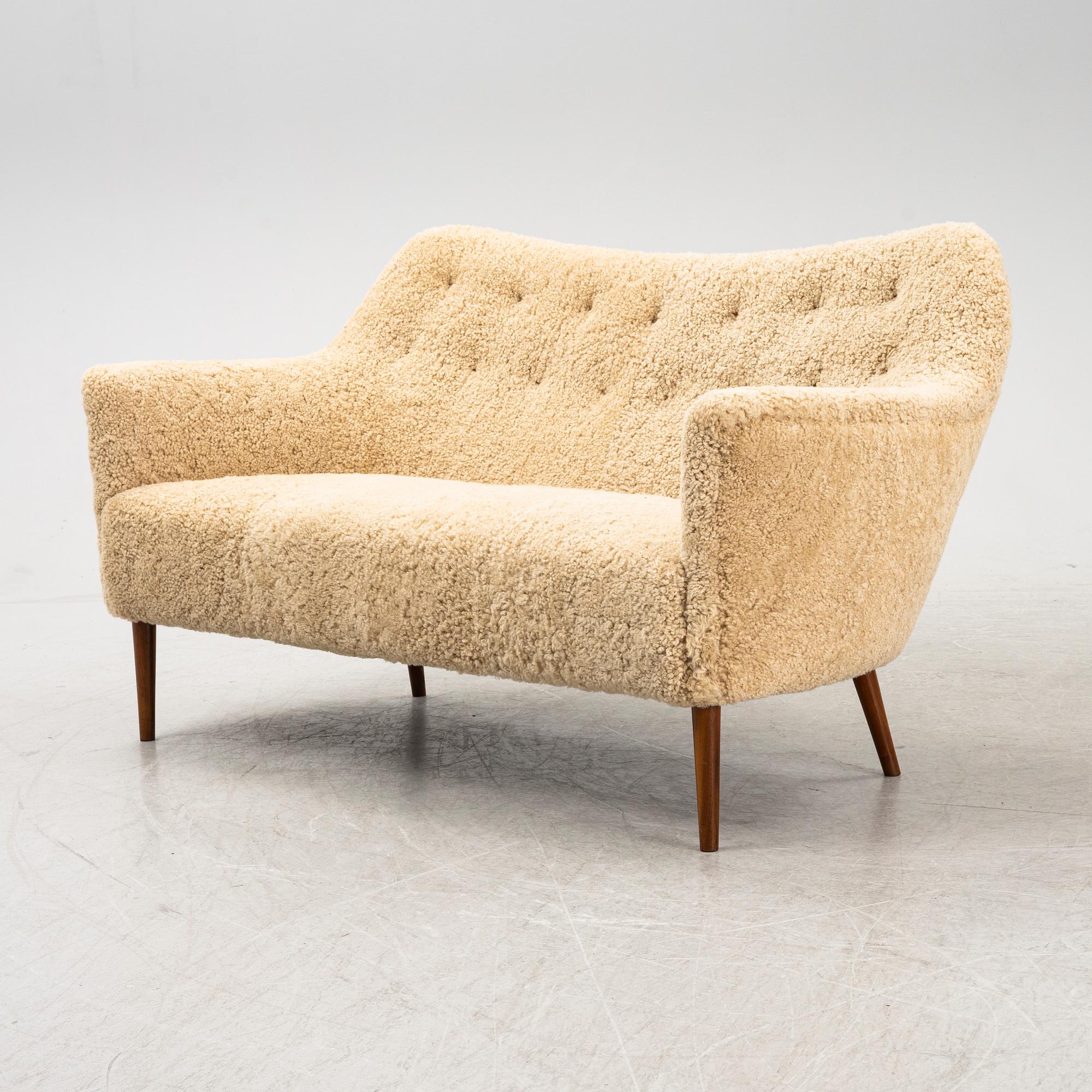 A mid 20th Century sofa with teak legs and new sheepskin upholstery, possibly by Carl Brorup, Slagelse, Denmark.