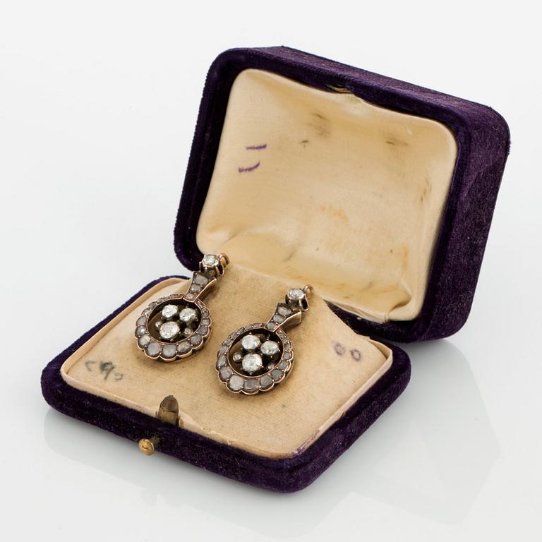 A pair of earrings set with rose-cut diamonds.