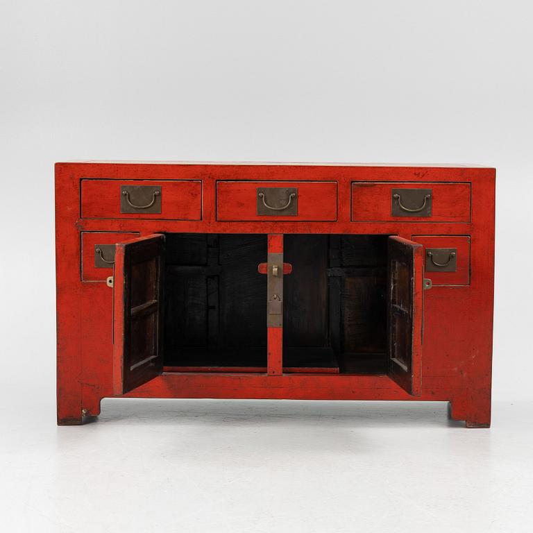 A Chinese red lacquered cabinet, 20th century.