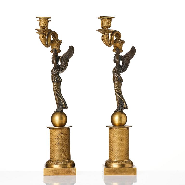 A pair of gilt and patinated bronze Empire-style two branch candelabra, later part 18th century.
